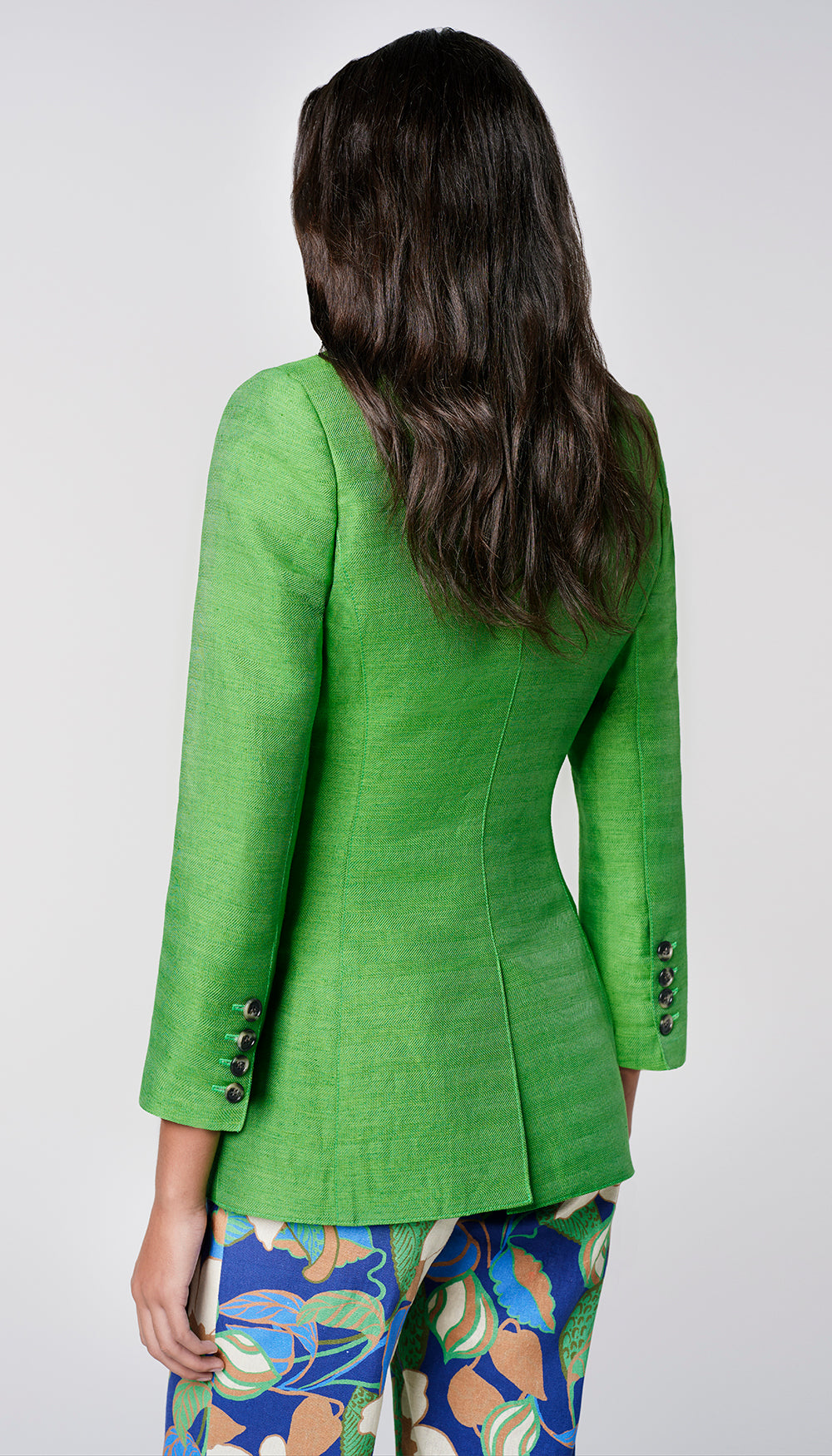 The back of a woman in a green blazer.