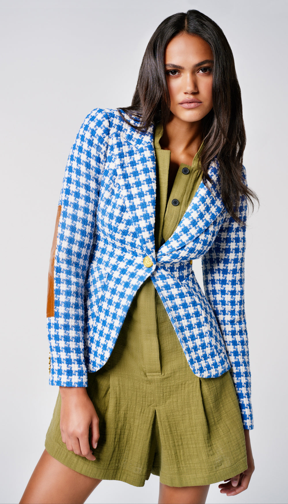 A woman in a blue and white houndstooth blazer.