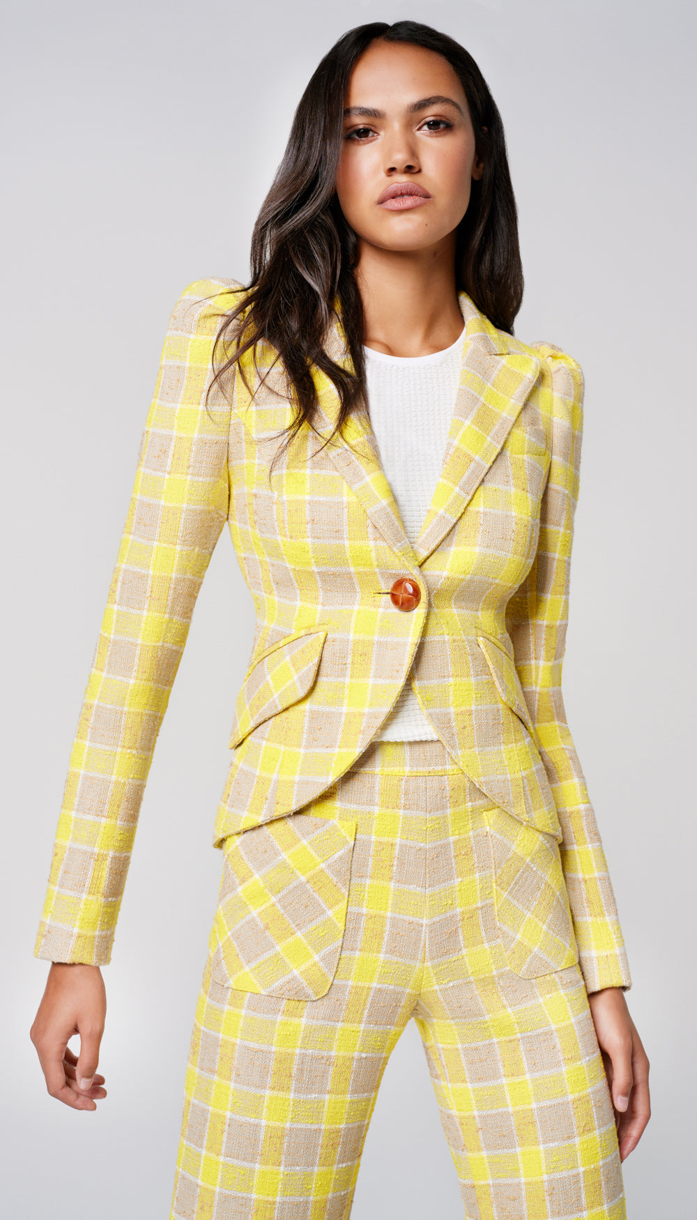 A woman in a yellow check blazer.