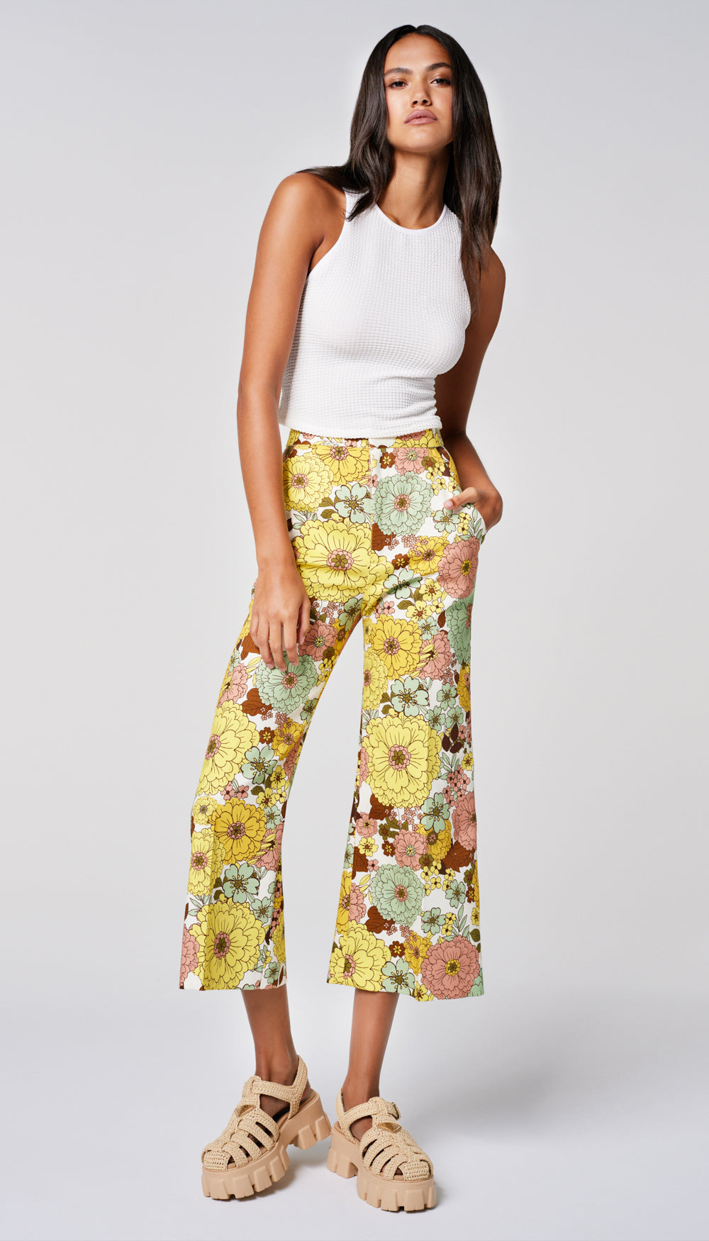 A woman in a yellow floral print pant.