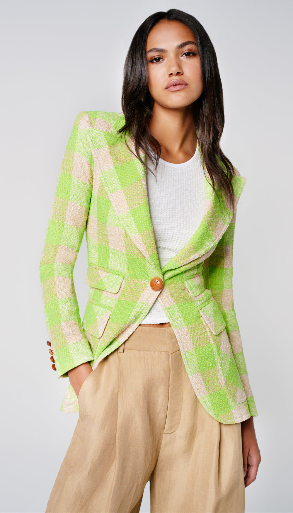 A woman in a green check blazer.