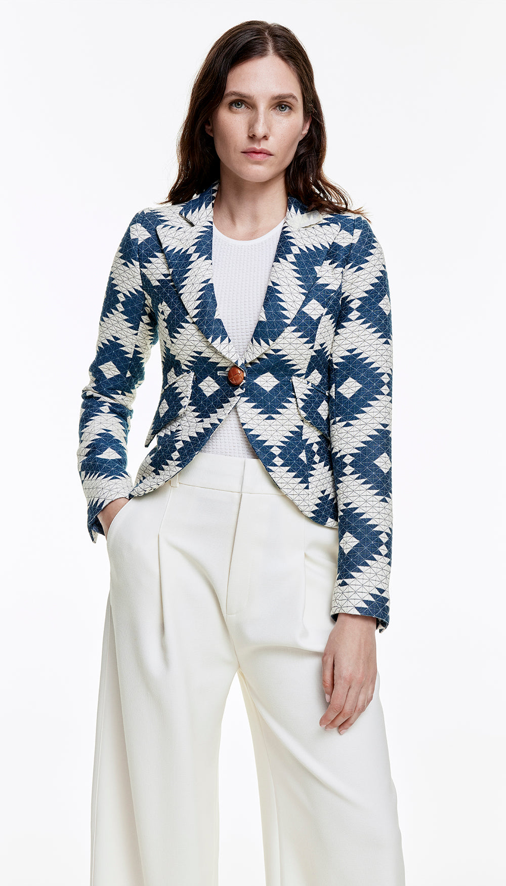 A woman in a blue and white quilted blazer.